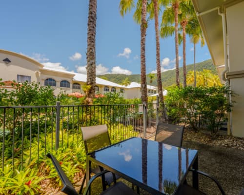 Courtyard of a 1 or 2 bedroom apartment at Mango Lagoon Resort, Palm Cove Cairns, leading out to the pool area with outdoor seating
