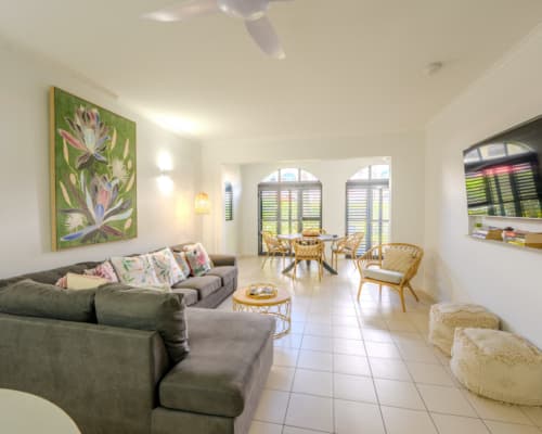 Lounge and dining area of a courtyard 1 or 2 bedroom apartment at Mango Lagoon Resort, Palm Cove Cairns