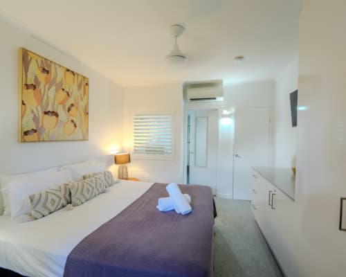 Master bedroom with king bed in a 1 or 2 bedroom apartment at Mango Lagoon Resort, Palm Cove Cairns