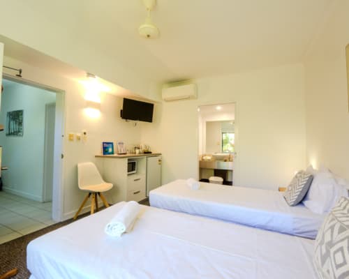 Studio room or second bedroom with twin beds and bathroom, connected to a 1 bedroom apartment to make a 2 bedroom apartment at Mango Lagoon Resort, Palm Cove Cairns