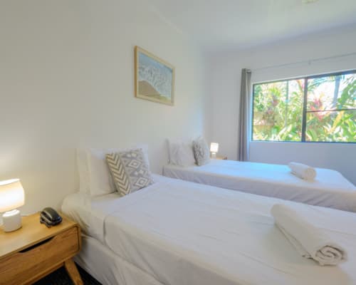 Twin bedroom with two beds in a 1 or 2 bedroom apartment at Mango Lagoon Resort, Palm Cove Cairns