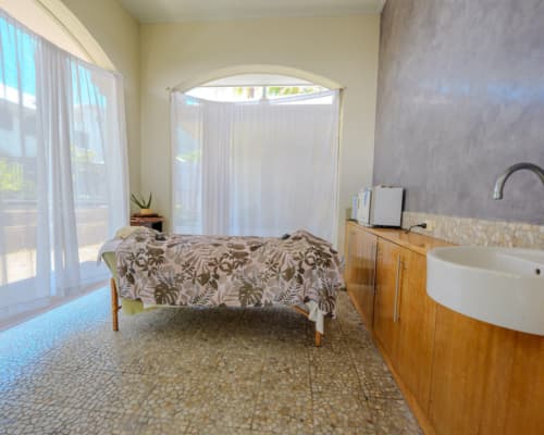 Treatment bed with sheer curtains letting in the breeze at the onsite Day Spa of Mango Lagoon Resort, Palm Cove Cairns